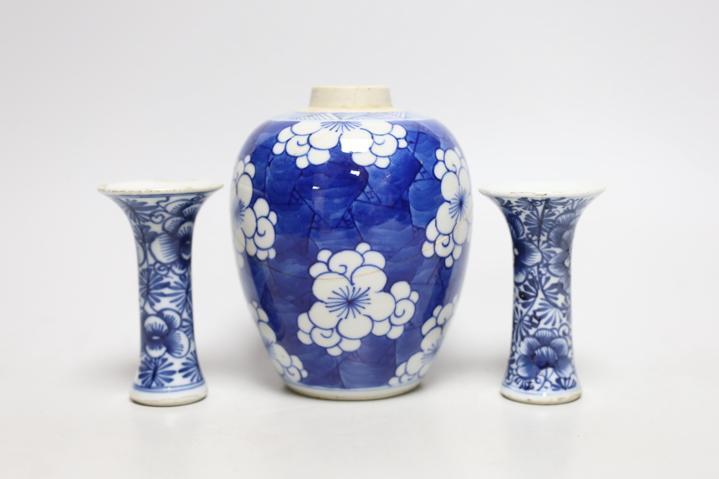 A Chinese blue and white prunus jar, two miniature vases and a dish, all Kangxi period, jar 14cms high